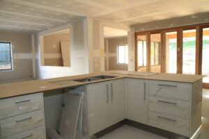 Cabinetry being installed | Featured image for the Fixing Stage of Construction Blog from ASBIR.