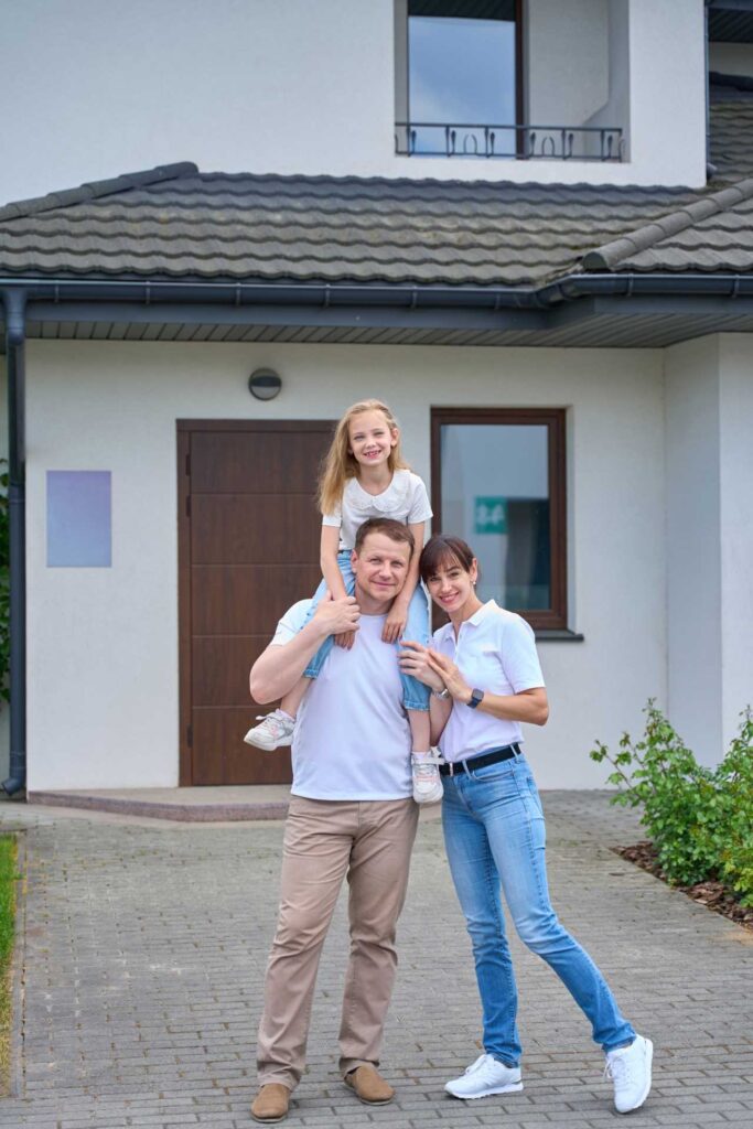 Family in front of a house | Featured Image for the Common Inspections Before Buying a House Blog by ASBIR.