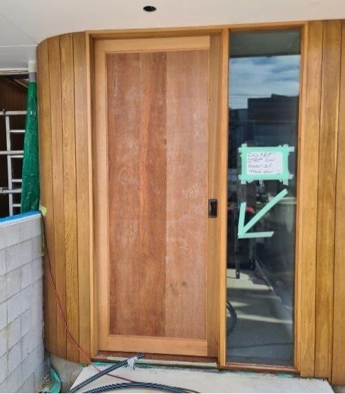 Front door of house in the enclosed stage of consturction. | Featured image for the Lock Up Stage: What It Means and Its Importance blog from ASBIR.